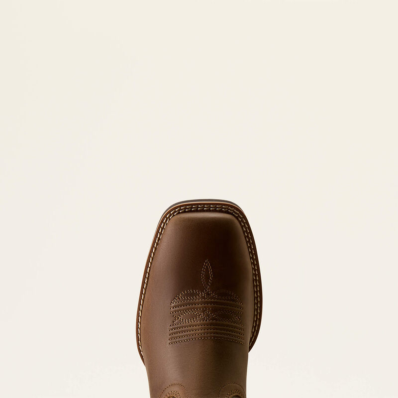 Toe of a brown leather Ariat boot on a white background