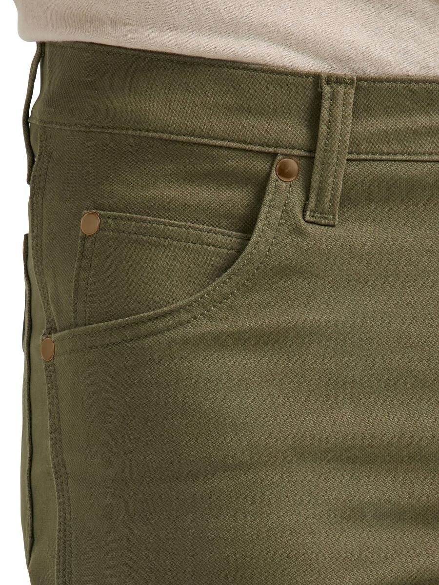 a close up of the front pocket of olive green wrangler cowboy but pants