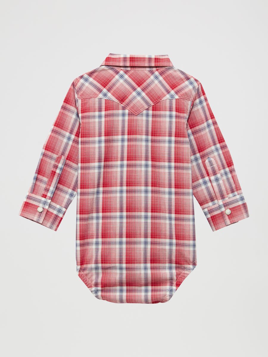 Red and white plaid baby shirt on a light gray background