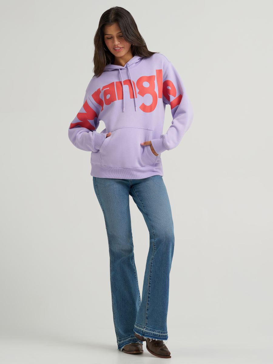 Person wearing a light purple hoodie with red text and blue jeans on a white background