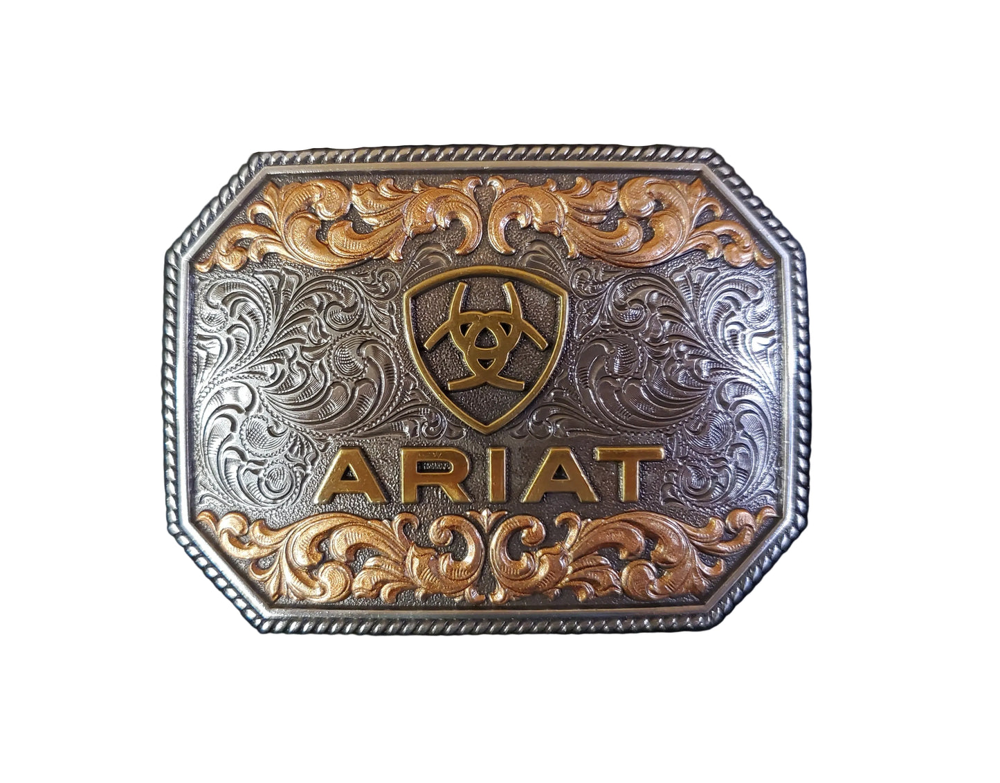 a rectangular rope edge belt buckle with copper floral detail and a gold ariat logo