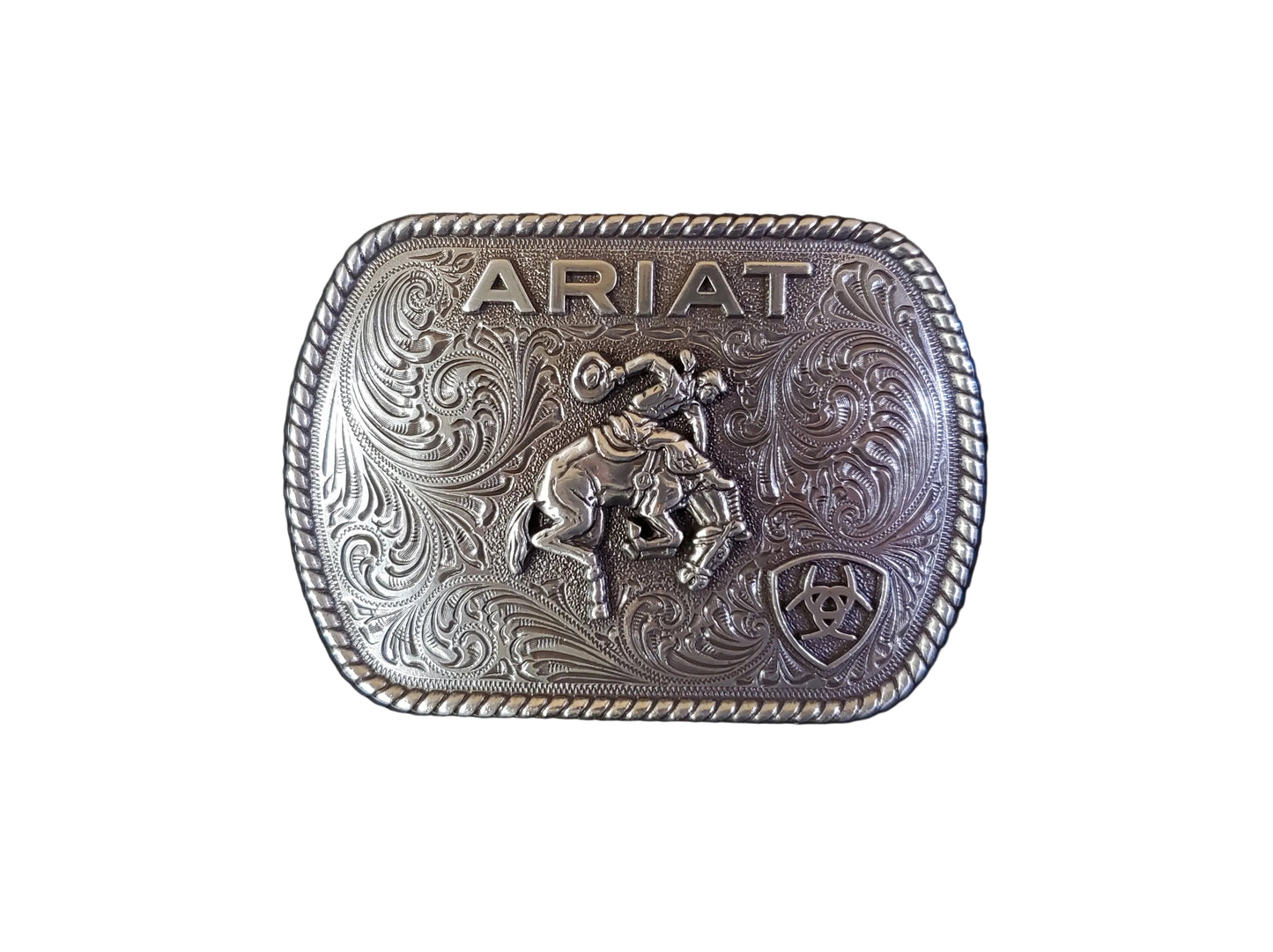 a silver rope edge belt buckle with a bronc rider and the ariat logo on it