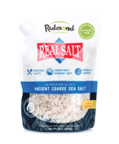 a bag of 'real salt' ancient coarse sea salt by redmond rock on a white background
