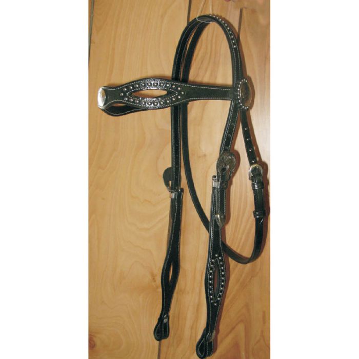 Black Ger-Ryan leather horse bridle with decorative elements on a wooden board
