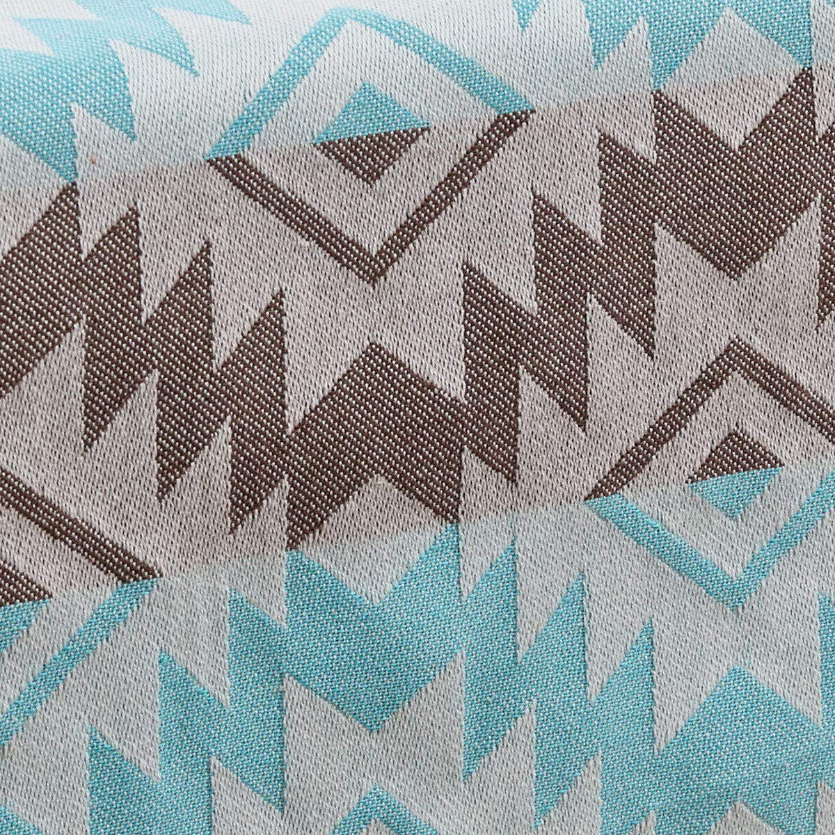 Close-up of fabric with geometric pattern in brown, blue, and gray.