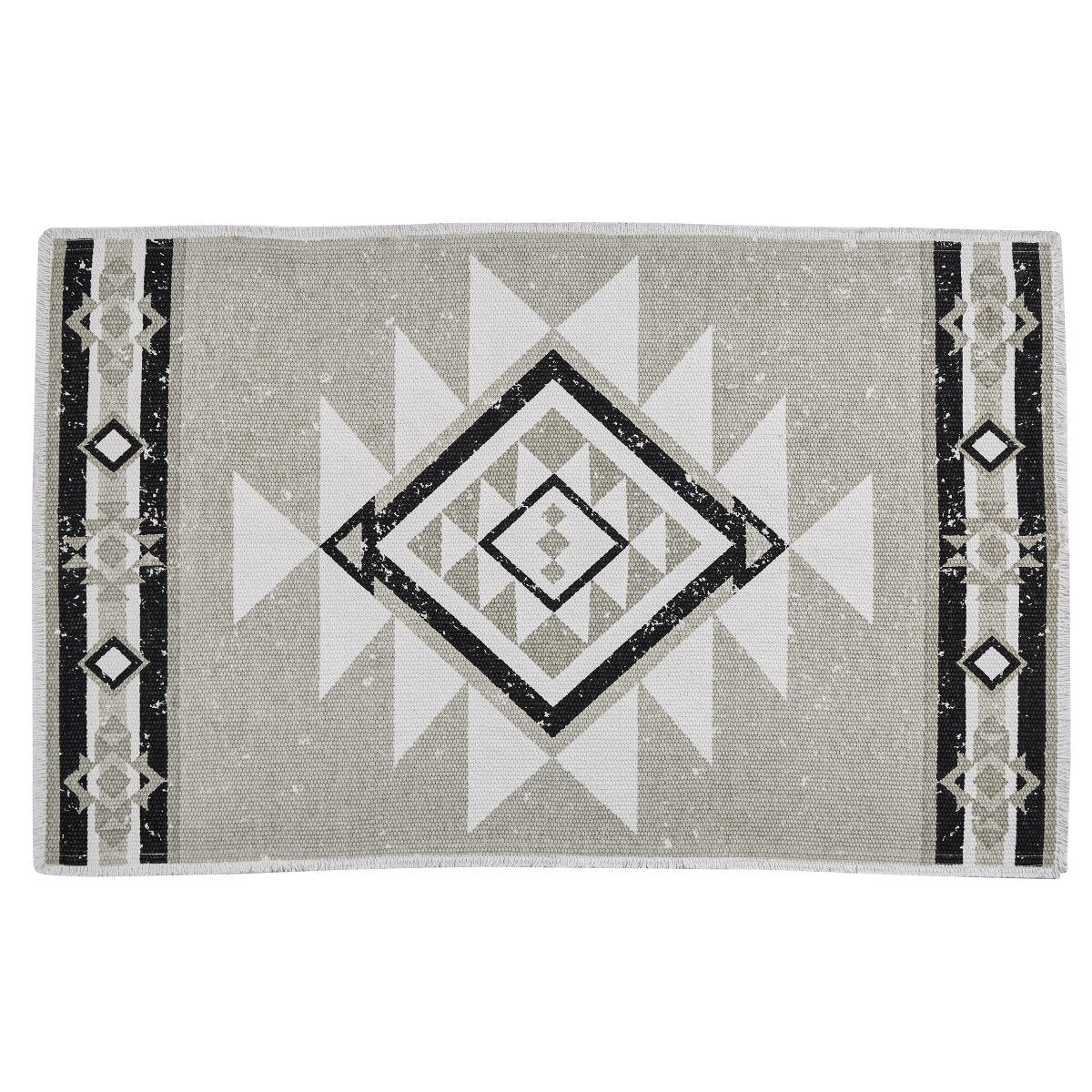 Gray rug with geometric black and white pattern on a white background