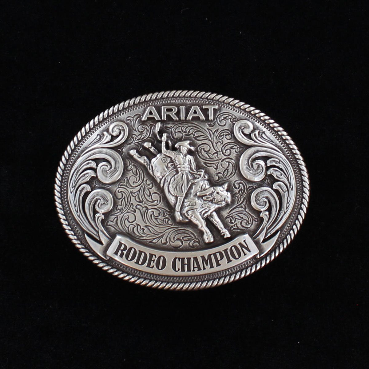 Silver Ariat Rodeo Champion belt buckle on a black background