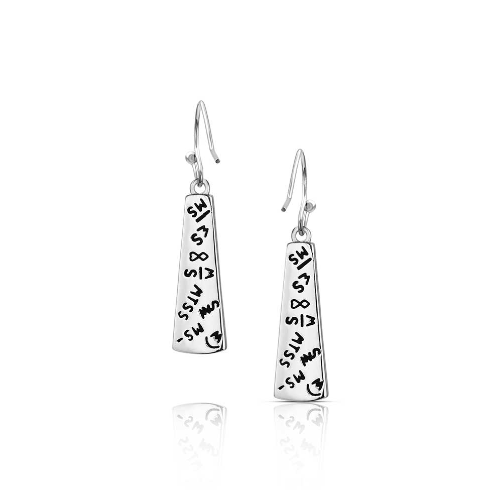 Pair of Montana Silversmiths earrings with engravings on a white background