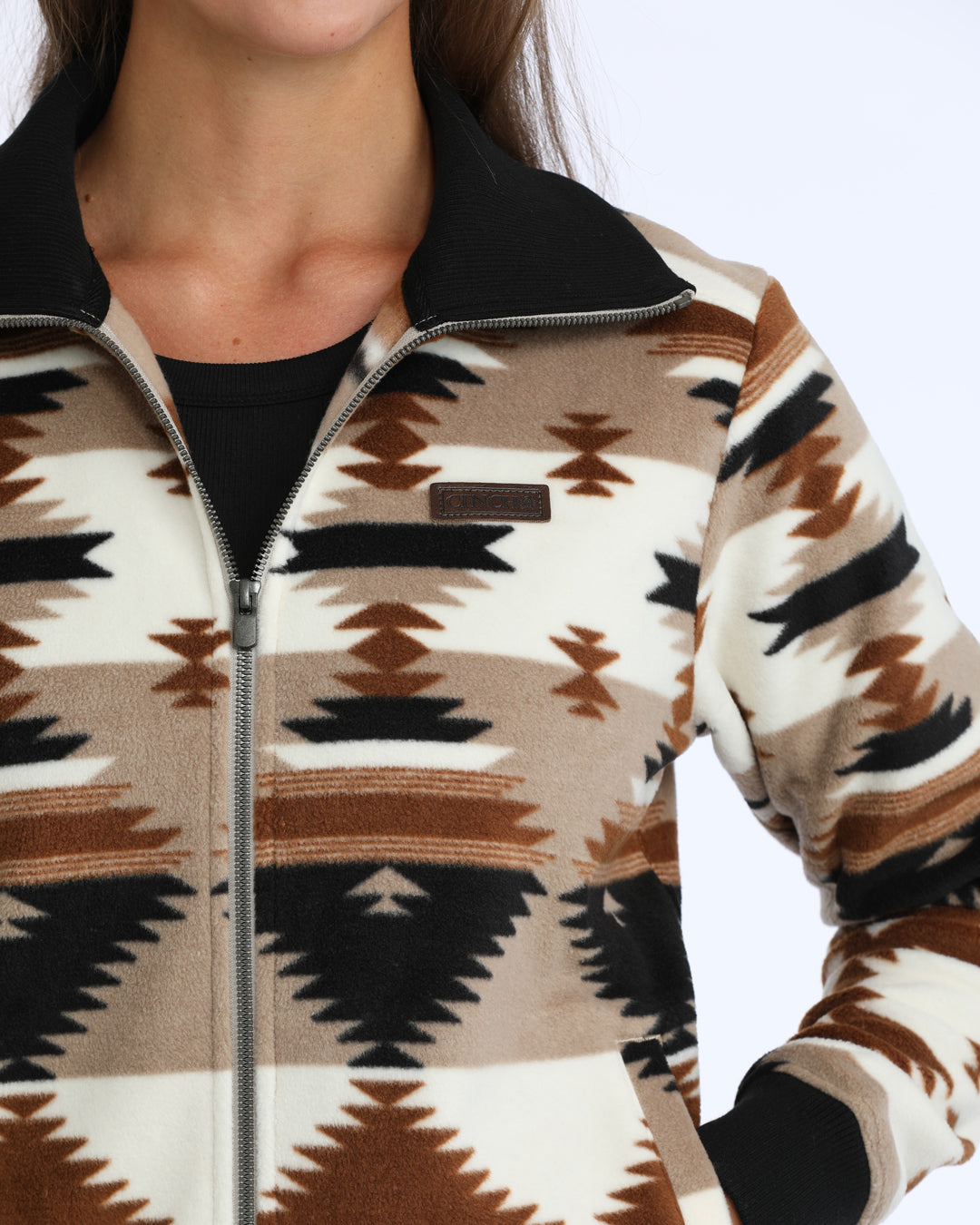 woman wearing an aztexc fleece sweater from Cinch on a white background
