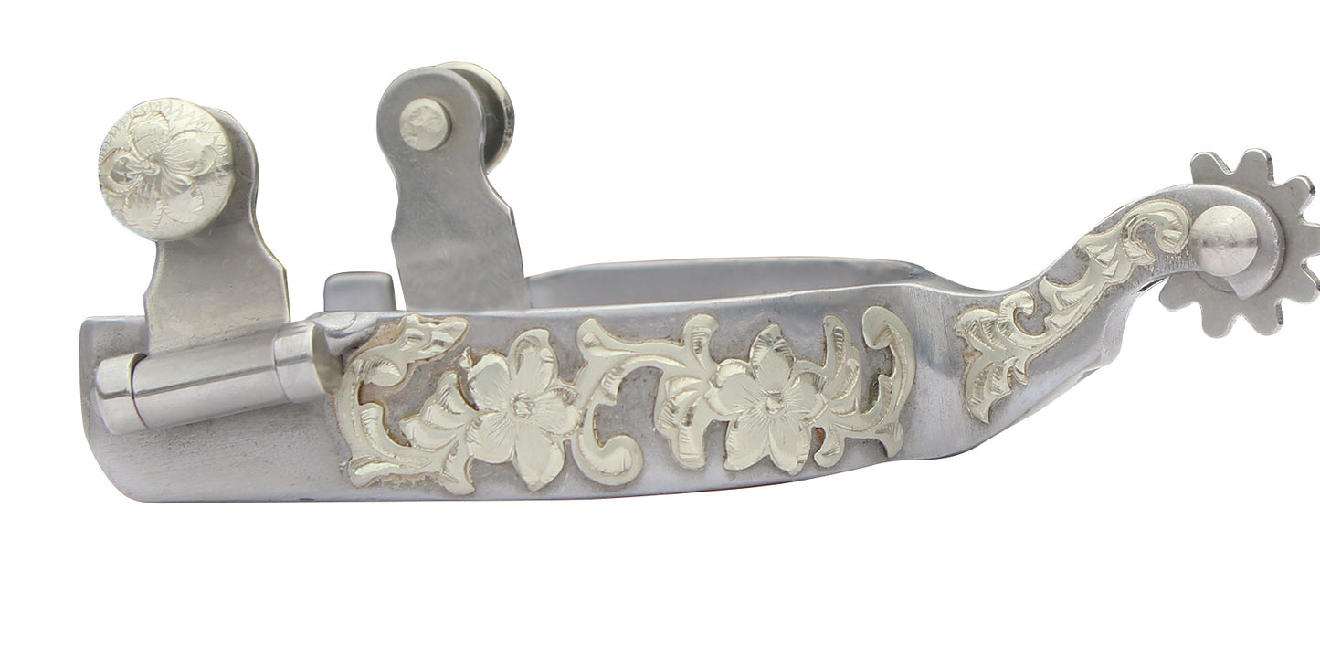 Decorative silver spur with intricate designs on a white background
