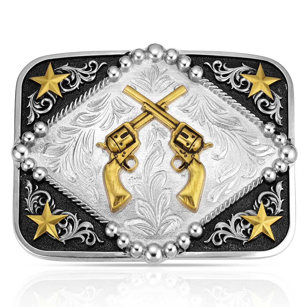 Montana Silversmiths Belt buckle with gold revolvers, stars, and decorative patterns on a black background
