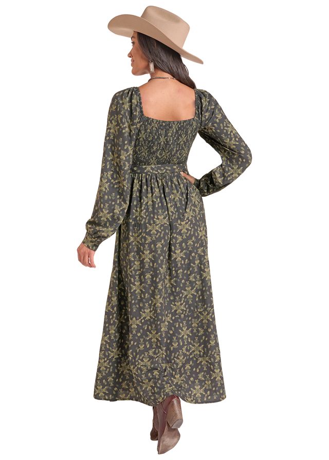 Woman wearing a green and black long dress by Panhandle Slim and a brown cowboy hat on a white background