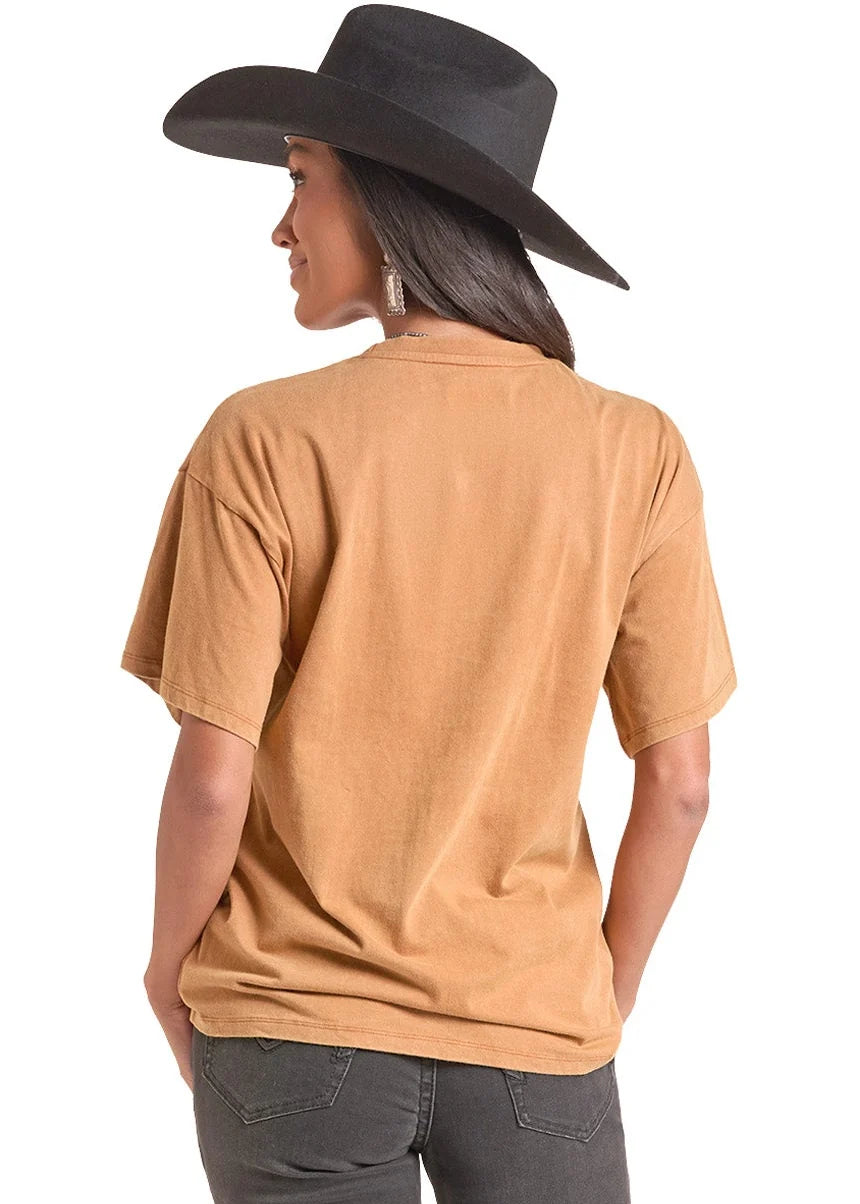 woman wearing an orange Rock&Roll Denim tshirt, black jeans and a black cowboy hat on a white background
