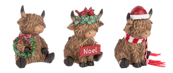 Three Highland cow Christmas figurines from Ganz on a white background. The left cow holds a green wreath with a red bow.