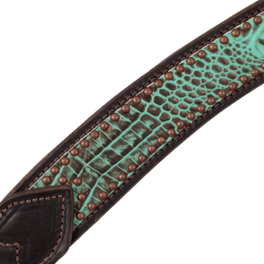 Close-up of a turquoise leather strap with brown studs on a white background