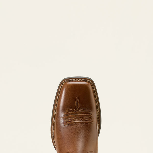 Close-up of a brown Ariat leather boot sole on a beige background