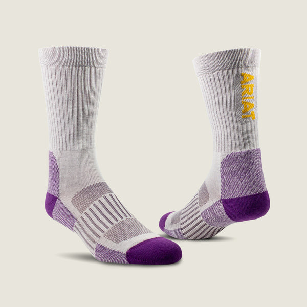 A pair of crew socks in light gray and purple with a yellow ARIAT logo on the side, displayed against a light beige background.