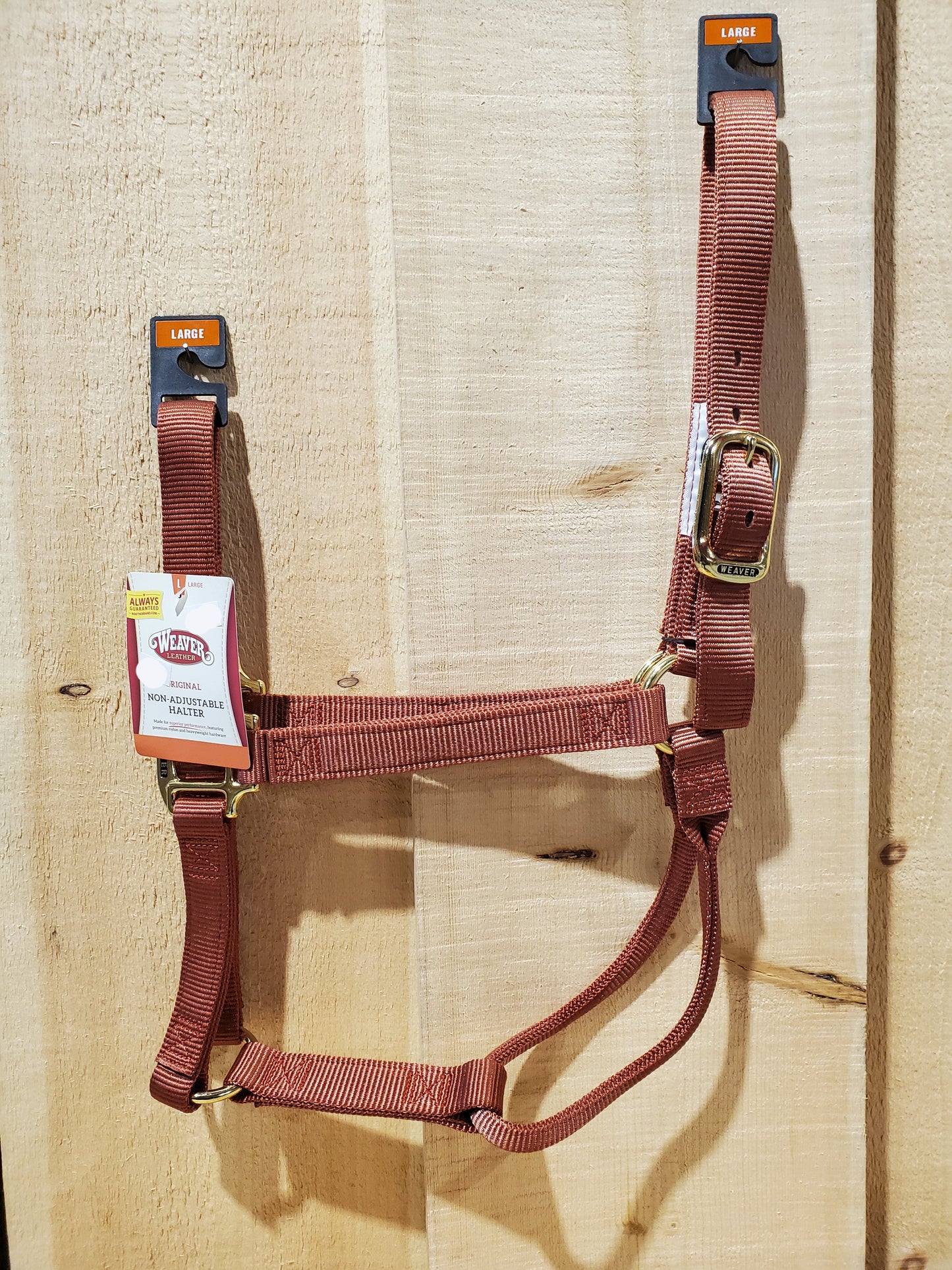 cinnamon brown nylon horse halter with brass hardware on a white background