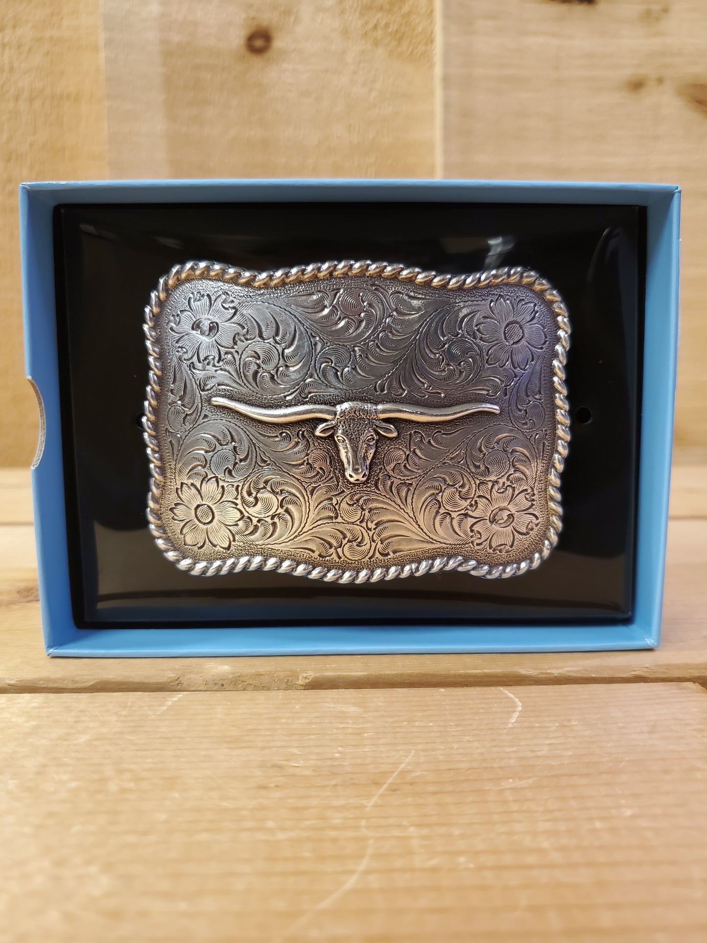 a rope edge rectangular belt buckle with a texas longhorn on it