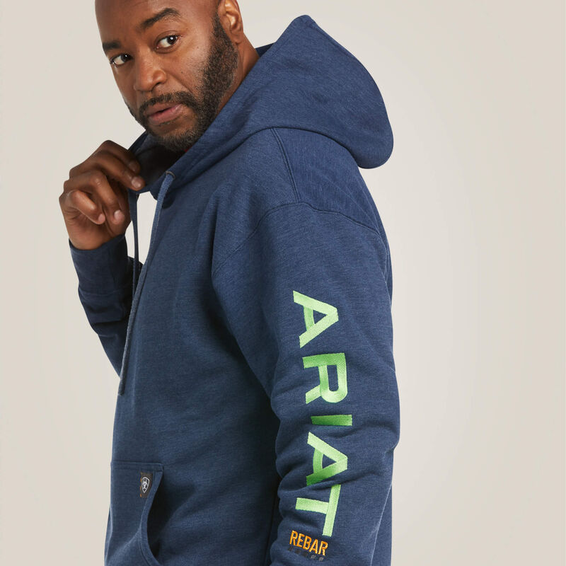 Man wearing a blue hoodie with 'Ariat' branding on a plain background