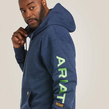 Man wearing a blue hoodie with 'Ariat' branding on a plain background