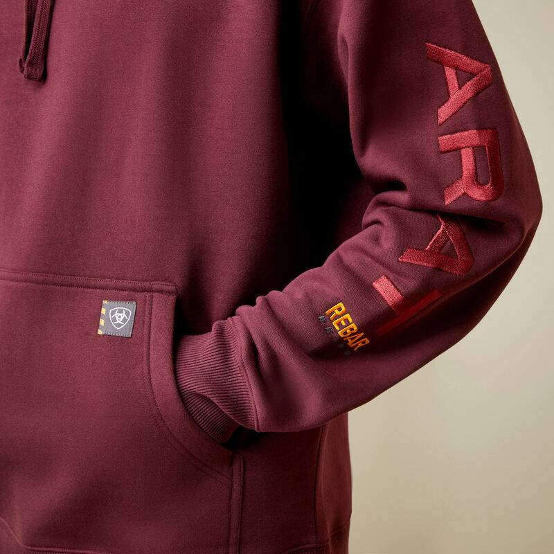 Maroon hoodie with 'Ariat' branding on a beige background