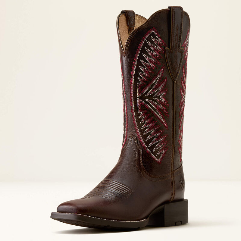 Dark brown leather Ariat boot with pink stitching on a white background