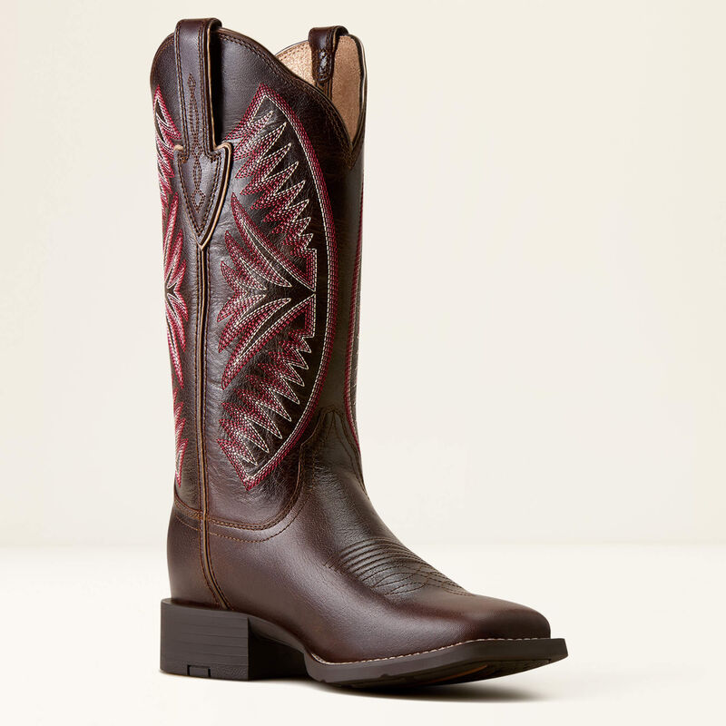 Dark brown leather Ariat boot with pink stitching on a white background