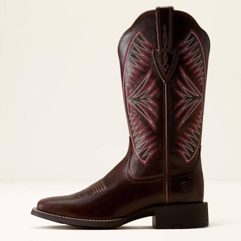 Dark brown leather Ariat boot with pink stitching on a white background