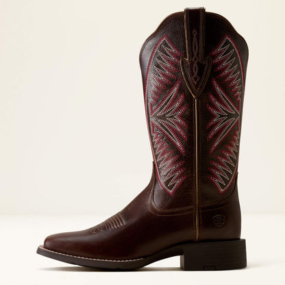 Dark brown leather Ariat boot with pink stitching on a white background