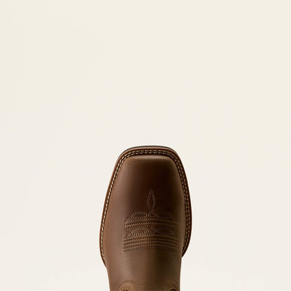 Toe of a brown leather Ariat boot on a white background