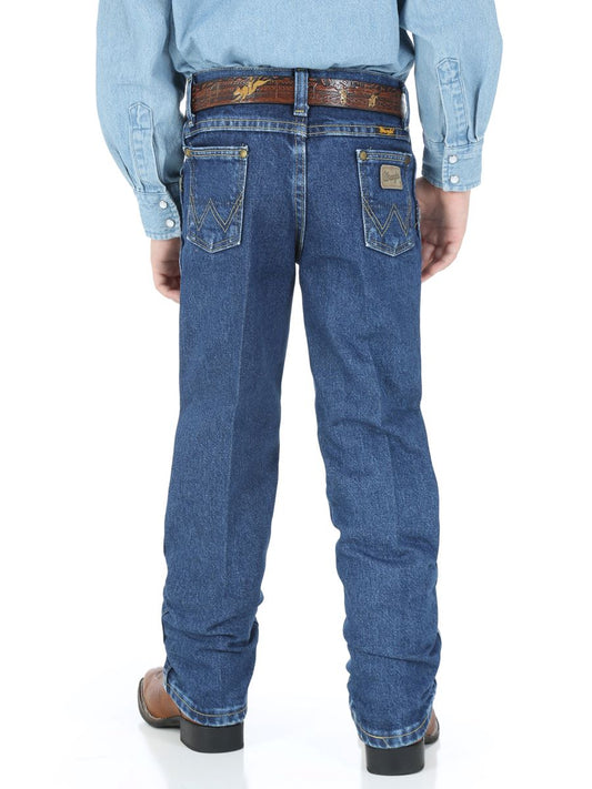 Boy wearing blue jeans with a visible brand logo on a white background