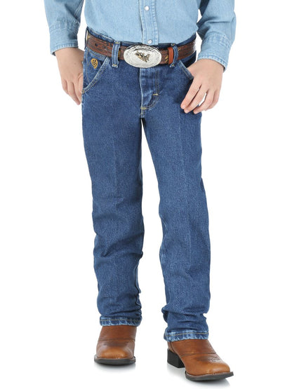 Boy wearing blue jeans, a light blue shirt, and brown boots on a white background