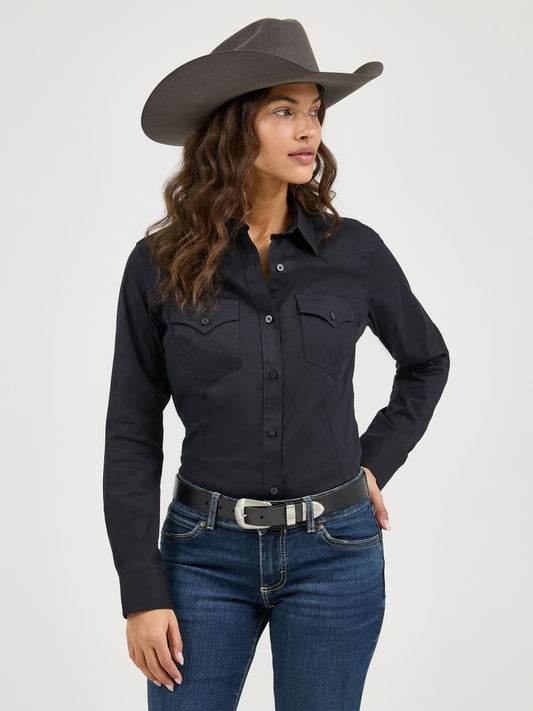 Woman wearing a black Wrangler shirt, blue jeans, and a gray cowboy hat on a white background