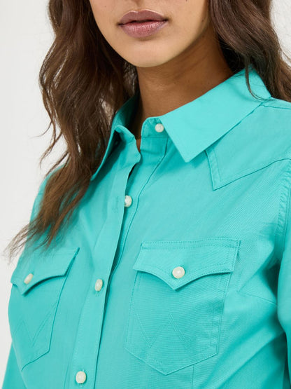 Teal Wrangler shirt worn by a person with a neutral background