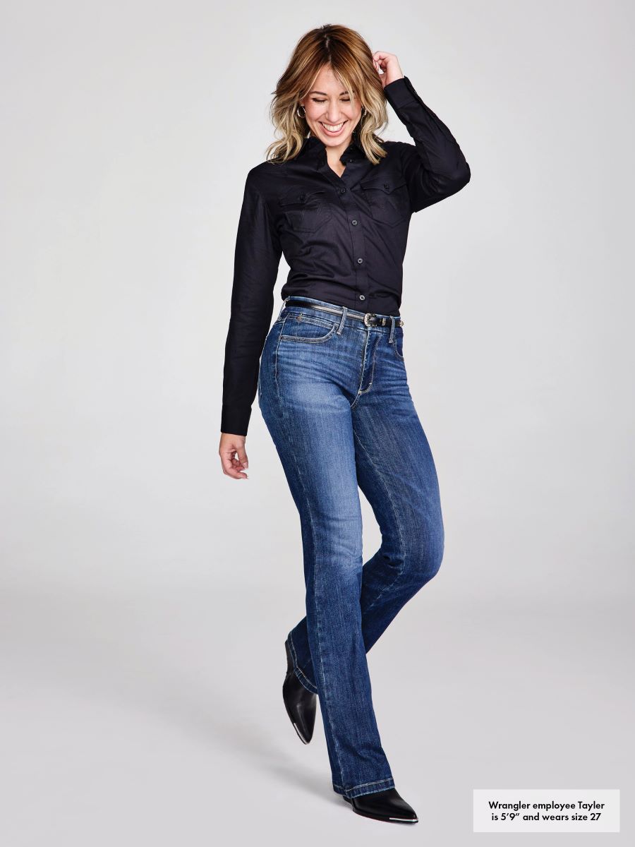 Woman wearing blue jeans and a black shirt on a white background