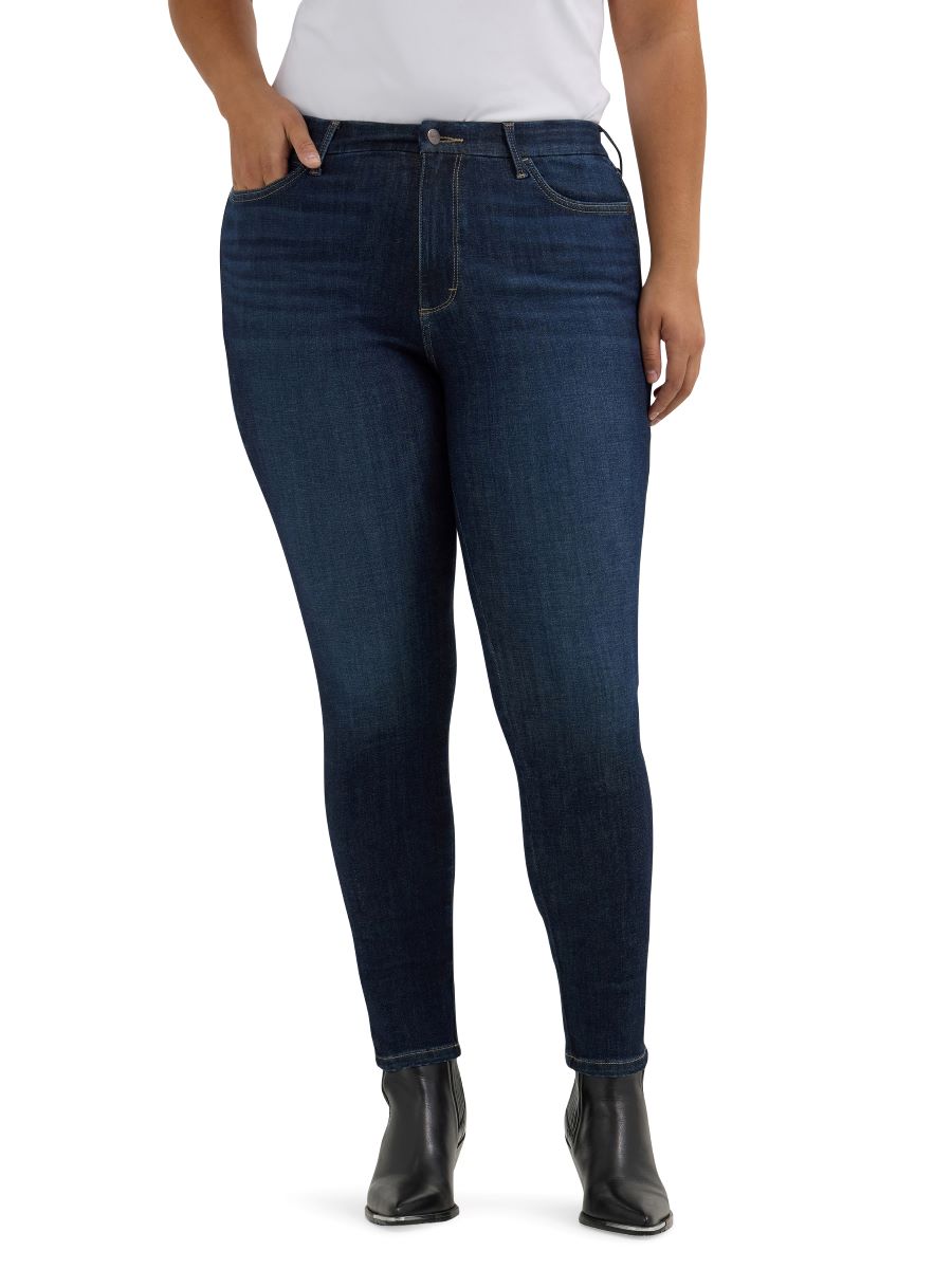 Dark blue jeans worn by a person on a white background
