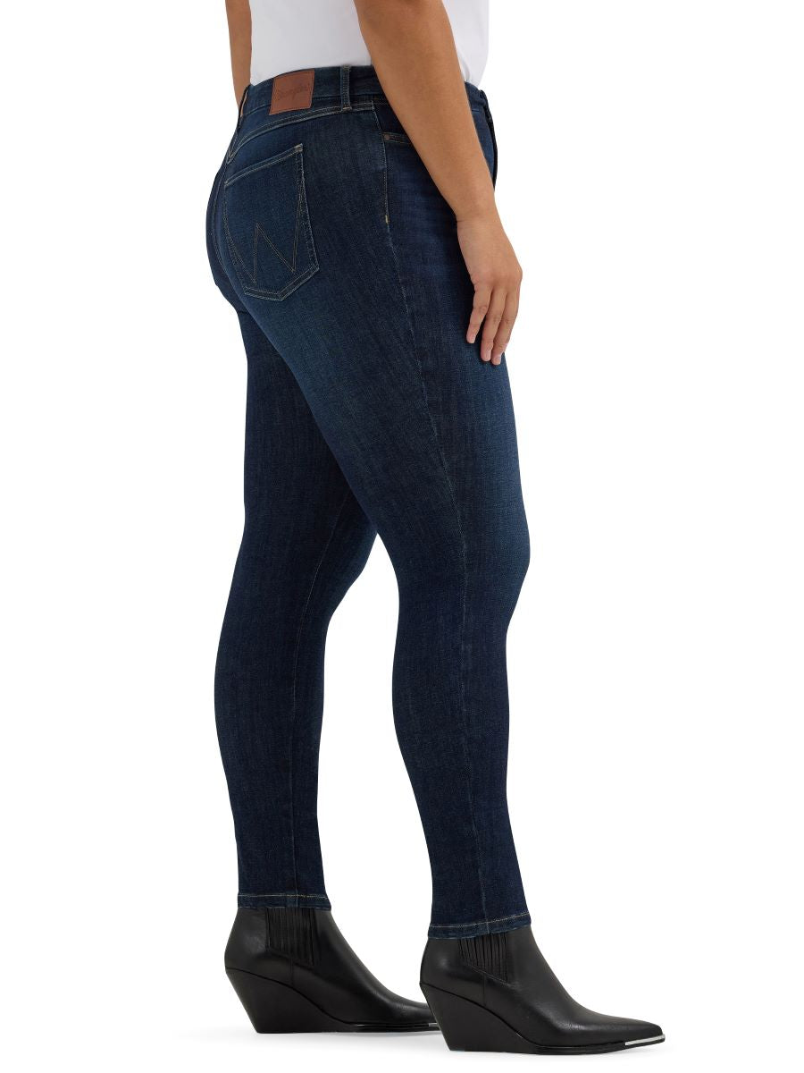 Dark blue jeans worn by a person on a white background