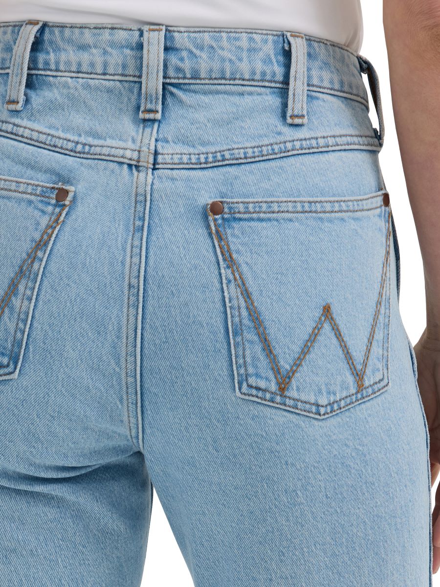 a close up of the pocket of a pair of lightwash wrangler jeans