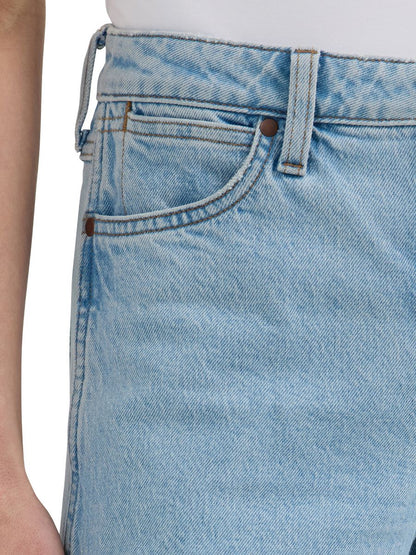 a close up of the hip of a pair of lightwash jeans
