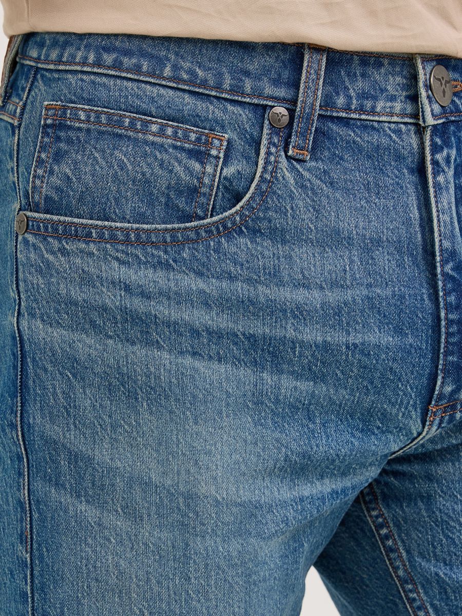 Close-up of blue Wrangler jeans with a focus on the pocket and stitching.