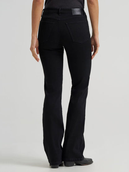 a woman wearing black pants on a grey background