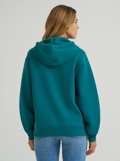 Person wearing a teal hoodie on a plain background