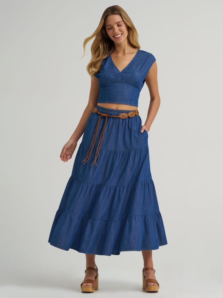 Woman wearing a blue dress with a belt on a white background