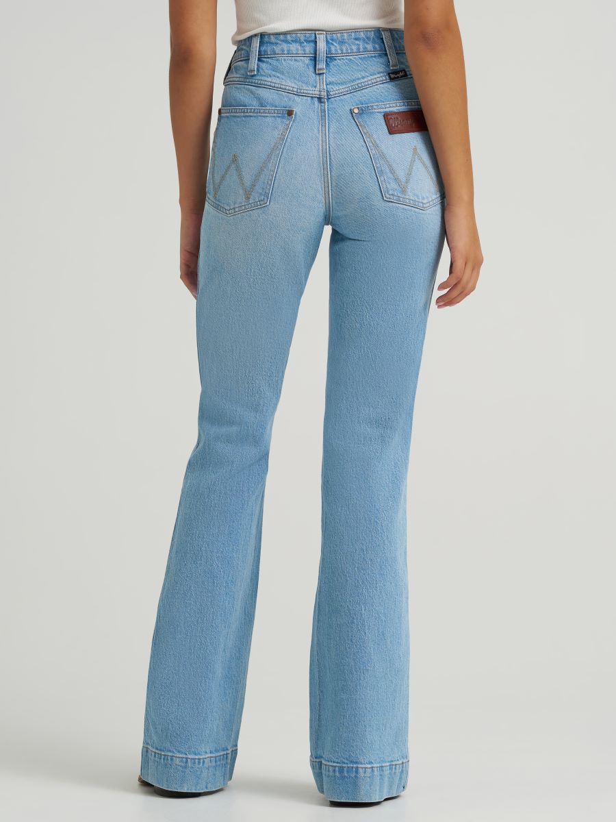 Light blue jeans worn by a person on a plain background