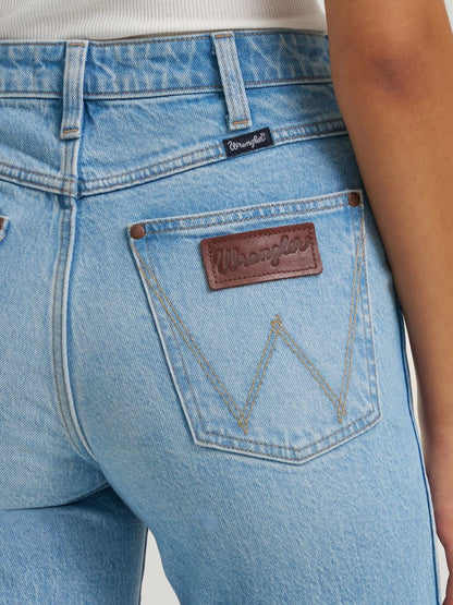 Close-up of blue jeans with Wrangler logo on pocket and label.