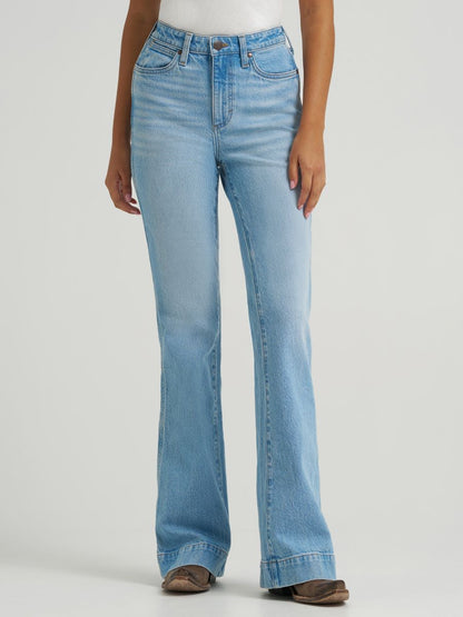 Light blue flared jeans worn by a person on a white background