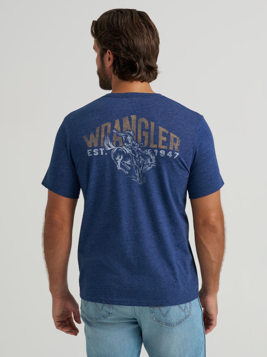 Man wearing a blue Wrangler t-shirt with branding on the back against a plain background