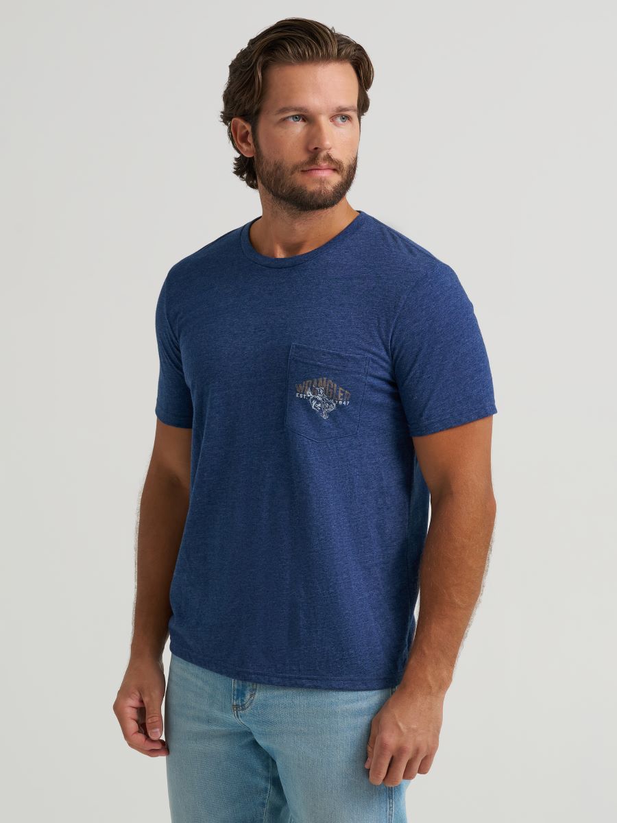 Man wearing a blue wrangler t-shirt with a logo on a light gray background