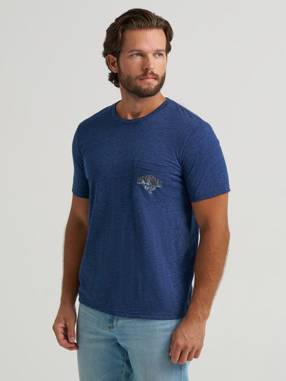 Man wearing a blue wrangler t-shirt with a logo on a light gray background